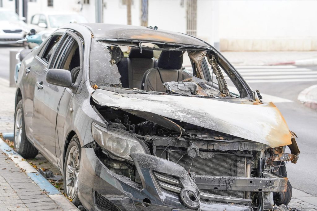 a car on the side of the road after a car fire