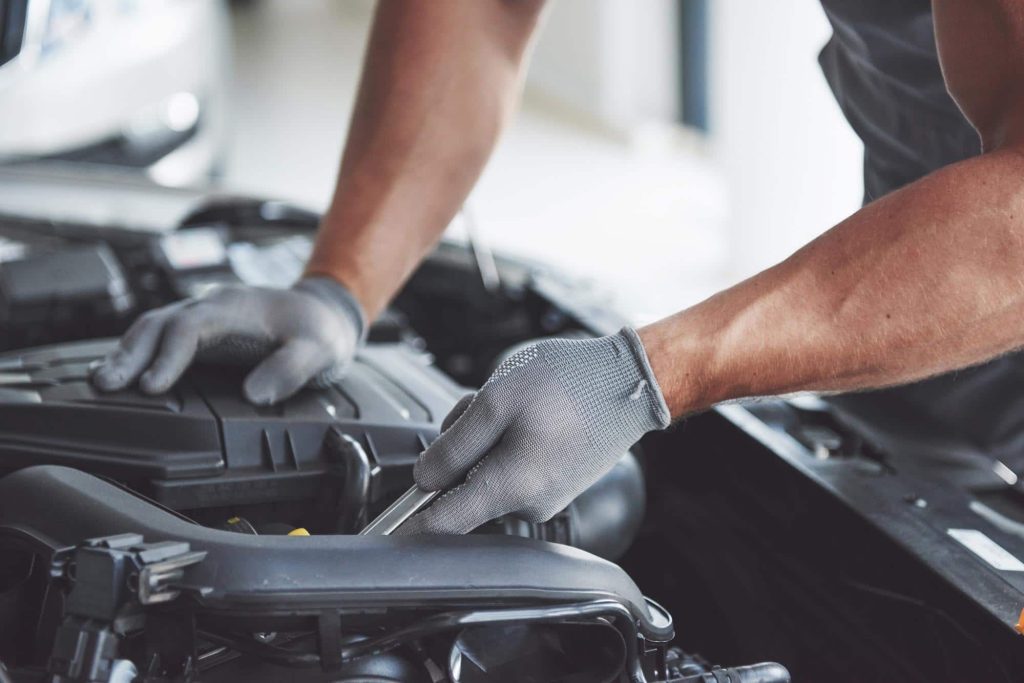 car mechanic fixing a car after being damaged in a car accident