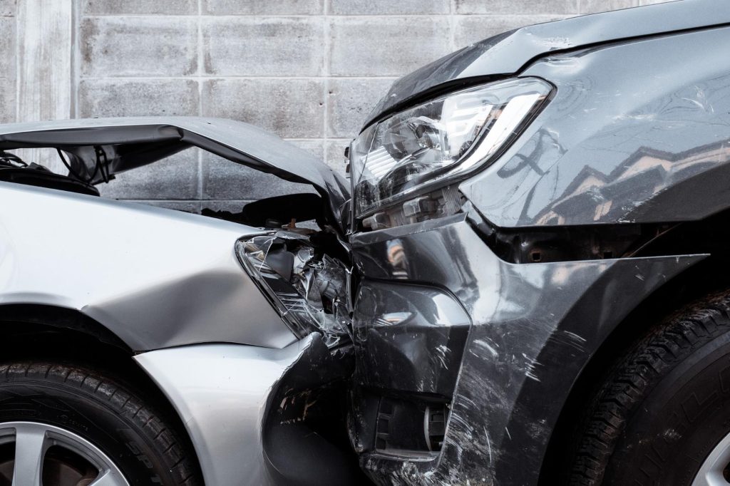 two vehicles with smashed front end after a head to head collision