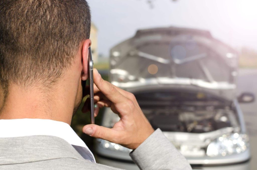 A man calls his insurance company after a minor car accident.