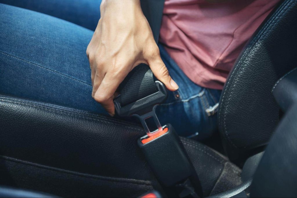 Man clicking seatbelt into place