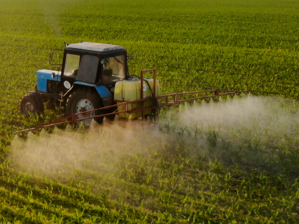 tractor sprays pesticides corn fields sunset closeup